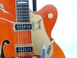 a close up of a guitar that is on a stand