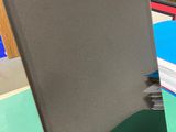 a laptop computer sitting on top of a green desk