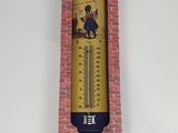 a close up of a thermometer on a brick wall