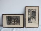 two framed drawings of a castle and a building on a white surface
