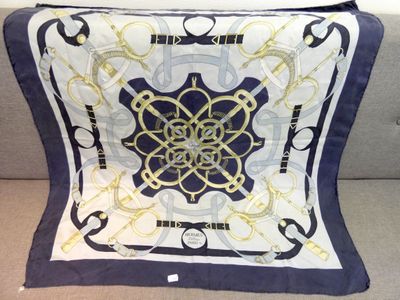 blue and white square scarf with a gold design on it