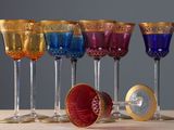 six wine glasses sitting on a table with a gold rim