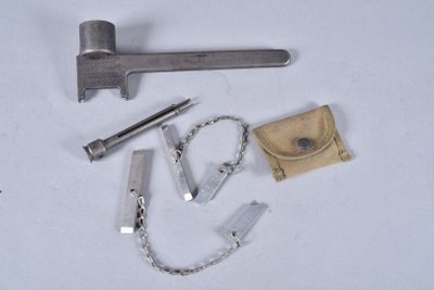 a hammer, chain, and other tools on a white surface