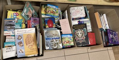 many books in a box on the floor