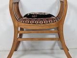 a wooden chair with a black cushion on top of it
