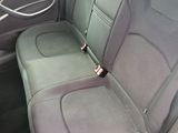 a seat in the back of a car with a bottle in it