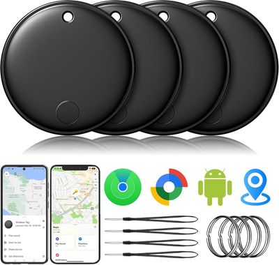 a set of four black gps trackers next to a phone and other gadgets