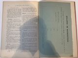a book open on a table with a shadow of a person