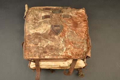 a brown bag with a brown handle on a gray surface