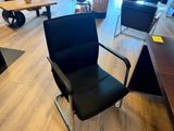 a black office chair in the middle of a room