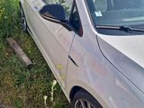 a silver car that is parked in the grass