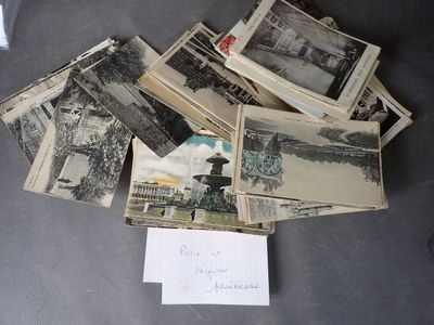 a pile of old black and white photos on a table