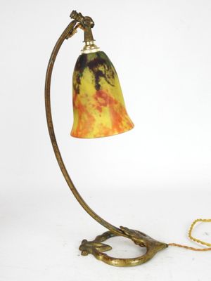 brass table lamp with a marbled glass shade and a chain