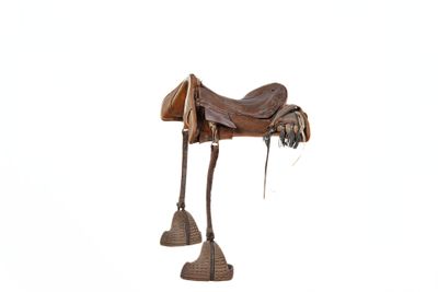 a wooden horse with a saddle on it ' s legs