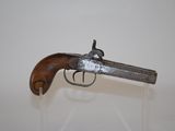 an old gun that is on display in a glass case