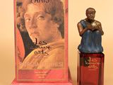 a small figurine of a woman next to a box of perfume