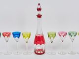 bottles and glasses are lined up in a row on a white surface