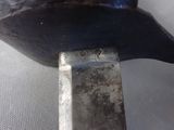 a close up of a metal object with a knife in it