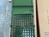 a box with a cage on top of it next to a box with a bird in it