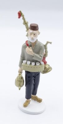 a figurine of a man with a pipe and a bag