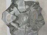 a glass ashtray with a glass figure on it