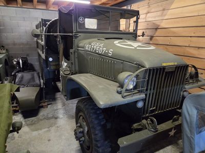 a military truck that is parked in a garage
