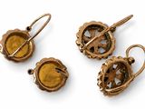 three pieces of jewelry are shown on a white surface