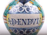 a blue and white vase with a name on it
