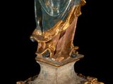 an antique statue of a woman holding a baby in her arms