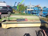 a green machine that is sitting on the side of the road