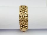 a close up of a gold bracelet on top of a napkin