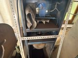 a metal shelf with a metal object on top of it