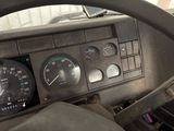 a dashboard of a truck with a clock and gauges
