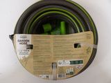 a green hose that is in a box on a table