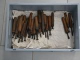 a lot of wooden tools in a box on the floor