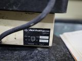 a close up of a machine on a table with a book