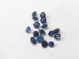 a group of blue sapphires sitting on top of a white surface