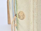 an open book with a string tied to the front of it
