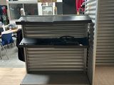 an image of a metal shelf in a store with a lot of items on it