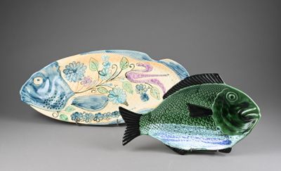 two decorative fish figurines sitting next to each other