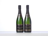two bottles of champagne sitting next to each other on a table