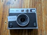 a camera sitting on a wooden table on a table