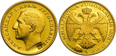 a close up of two gold coins with a man ' s face