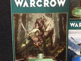 three games of warcraw on display on a black surface
