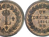a coin with a crown on it and a wreath around it