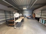 a room that has a lot of shelves and tables in it