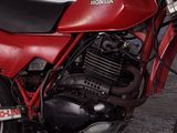 a red motorcycle that is parked in a garage