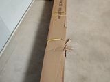a large cardboard box sitting on the floor next to a pile of boxes