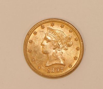 a close up of a gold coin on a white surface