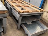 many pieces of metal on a table in a factory